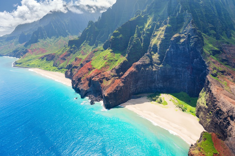 Hawaii beach bordered by cliffs